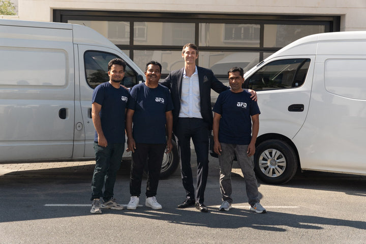 Tim Garrett and the GymFitOut Dubai installation team with their delivery vans